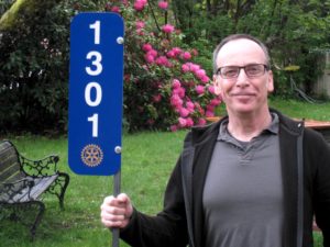 Rotary home number sign held by President-Elect Ross Patterson